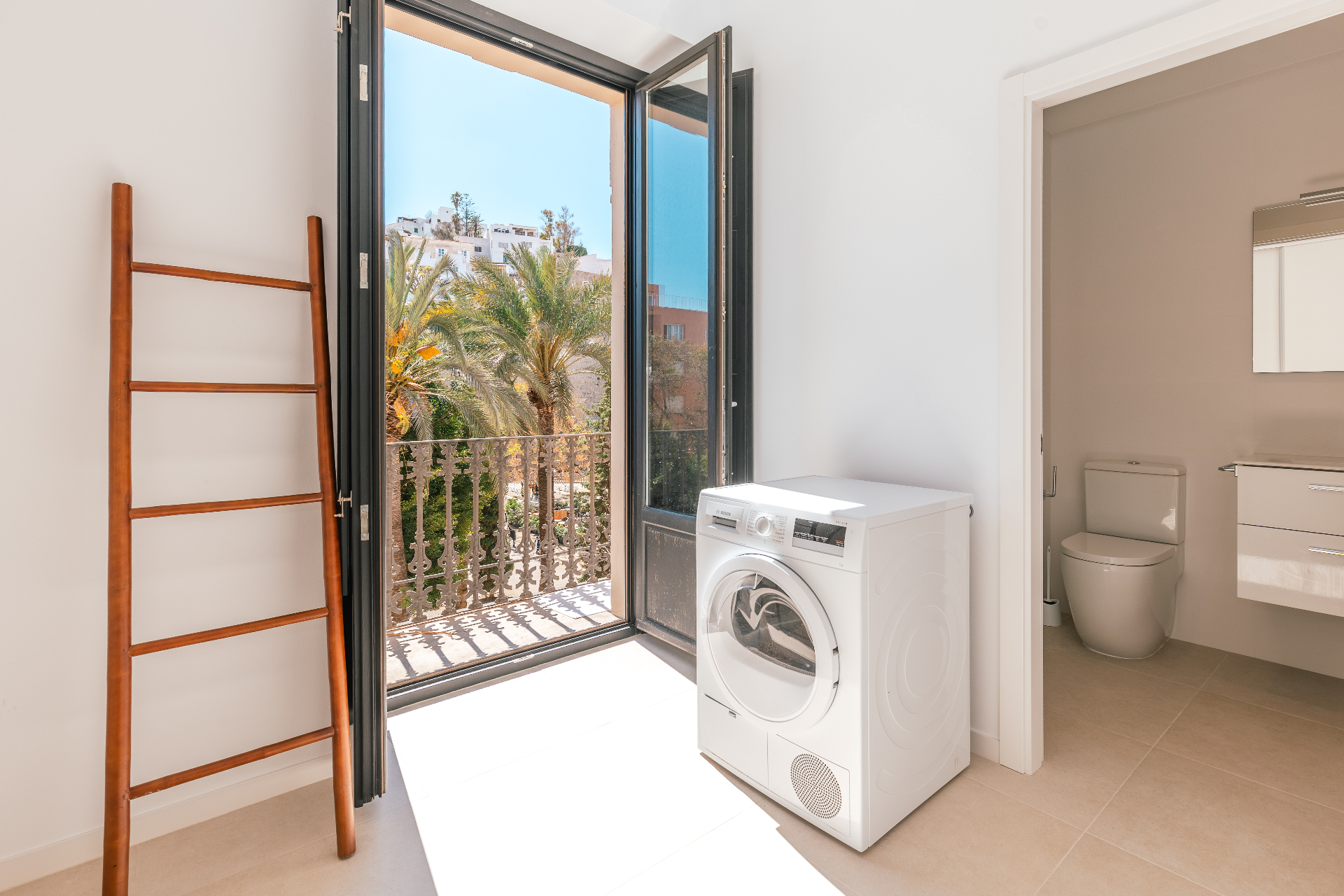 Balcony with palm view and laundry area