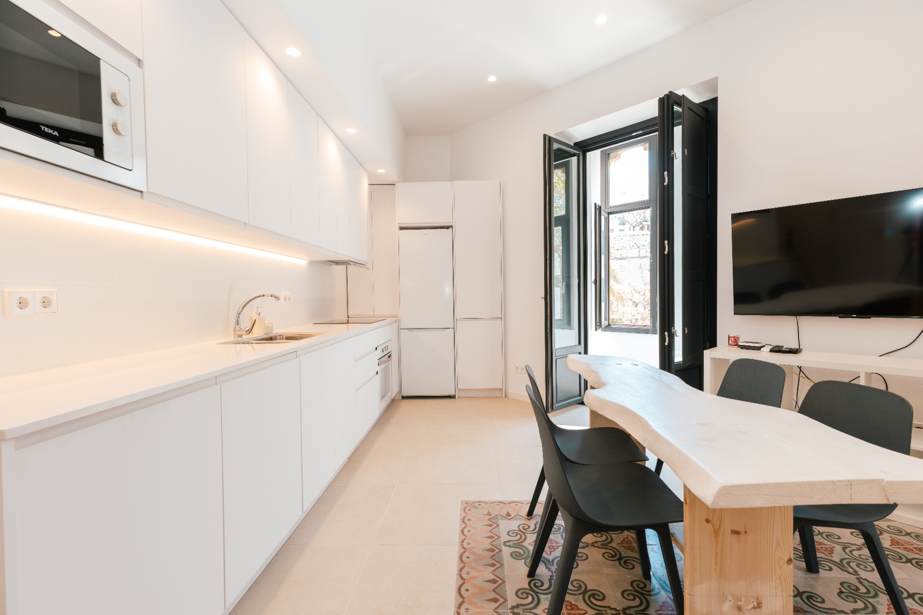 Modern white kitchen with balcony